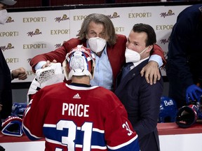 Montreal Canadiens general manager Marc Bergevin and assistant coach Luke Richardson congratulate goaltender Carey Price (31) after the Canadiens defeated the Vegas Knights to advance to the Stanley Cup final during NHL semi final game 6  in Montreal on Thursday, June 24, 2021.