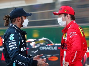 Lewis Hamilton talks with pole position qualifier Charles Leclerc during qualifying ahead of the F1 Grand Prix of Azerbaijan at Baku City Circuit on Saturday, June 5, 2021, in Baku, Azerbaijan.
