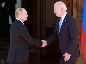 Russian President Vladimir Putin, left, shakes hands with U.S. President Joe Biden prior to their meeting at the Villa la Grange in Geneva on June 16, 2021.