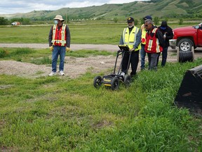 A crew performs a ground-penetrating radar search of a field, where the Cowessess First Nation say they have found 751 unmarked graves, near the former Marieval Indian Residential School in Grayson, Sask., on June 18, 2021.