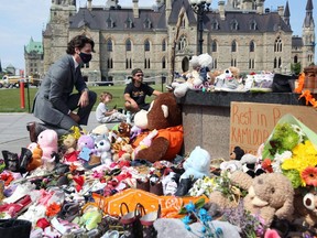In this photo taken on June 1, Prime Minister Justin Trudeau visits the makeshift memorial erected on Parliament Hill in honour of the 215 Indigenous children whose remains were found at a residential school in British Columbia.
