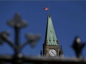 In this file photo a Canadian flag flies at half-mast on top of the Peace Tower on April 20, 2020.
