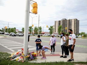 Members of the Selamati family lay flowers at the fatal crime scene where a man driving a pickup truck jumped the curb and ran over a Muslim family in what police say was a deliberately targeted anti-Islamic hate crime, in London, Ontario, Canada June 7, 2021.