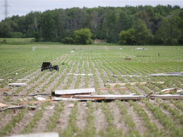 Debris is seen in a field in the aftermath of a tornado that touched down on the previous day in Mascouche on June 22, 2021.