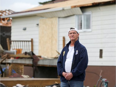 Michel Vachon surveys the damage around him in the aftermath of a tornado that touched down on the previous day and claimed the life of his neighbour, in Mascouche June 22, 2021.