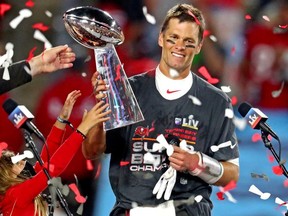 Tampa Bay Buccaneers quarterback Tom Brady celebrates with the Vince Lombardi Trophy after beating the Kansas City Chiefs in Super Bowl LV at Raymond James Stadium.