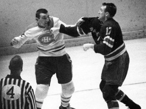 Montreal Canadiens' John Ferguson fights with New York Rangers' Bob Nevin in this 1964 file photo in New York. "Hockey will never become a clean game like soccer or baseball; it is too intense," Lise Ravary writes.
