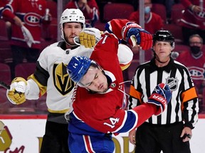Vegas Golden Knights defenseman Brayden McNabb (3) punches Montreal Canadiens forward Nick Suzuki (14) under the eye of referee Chris Lee (28) in game four of the 2021 Stanley Cup Semifinals at the Bell Centre.