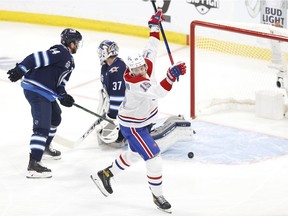 Canadiens centre Jesperi Kotkaniemi (15) scores a first period goal against Winnipeg Jets goaltender Connor Hellebuyck (37) in Game 1 of the second round of the 2021 Stanley Cup Playoffs at Bell MTS Place in Winnipeg on Wednesday, June 2, 2021.