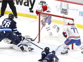 Montreal Canadiens centre Nick Suzuki  scores on Winnipeg Jets goaltender Connor Hellebuyck in the first period of Game 1 at Bell MTS Place in Winnipeg on June 2, 2021.