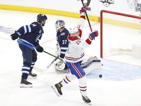 Montreal Canadiens centre Jesperi Kotkaniemi scores a first-period goal on Winnipeg Jets' Connor Hellebuyck in Game 1 at Bell MTS Place in Winnipeg on June 2, 2021.