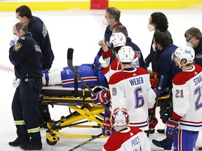 Montreal Canadiens centre Jake Evans gives a thumbs-up as he is stretchered off the ice against the Winnipeg Jets in Game 1 of the second round of the 2021 Stanley Cup playoffs at Bell MTS Place in Winnipeg on June 2, 2021.