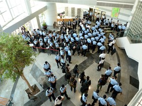 Police officers gather at the headquarters of Apple Daily in Hong Kong, China June 17, 2021.