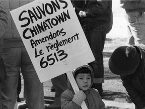 A child holds a sign at a March 11, 1985 protest against Bylaw 6513, which constrained Chinatown's commercial development.