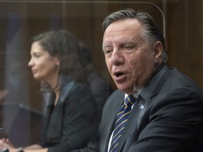 Quebec Premier François Legault speaks at a news conference marking the end of the spring session, Friday, June 11, 2021 at the legislature in Quebec City. Quebec Deputy premier and Public Security Minister Geneviève Guilbault looks on.