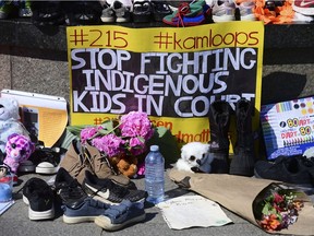 A poster is placed as part of a memorial at the Centennial Flame on Parliament Hill in Ottawa on Wednesday, June 2, 2021 in recognition of discovery of children's graves at the site of a former residential school in Kamloops, B.C. "If the Canadian government truly wanted to celebrate Indigenous peoples, surely it wouldn’t be fighting residential school survivors in costly legal battles, right?" Brandon Montour writes.
