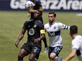 CF Montréal midfielder Victor Wanyama looks to settle the ball past Vancouver Whitecaps midfielder Russell Teibert (31) in the first half at Rio Tinto Stadium in Sandy, Utah, on May 8, 2021.