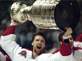 Canadiens goalie Patrick Roy hoists the Stanley Cup at Montreal Forum after beating the Los Angeles Kings in 1993. No Canadian team has won the Cup since.