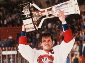 Canadiens captain Guy Carbonneau hoists the Prince of Wales Conference trophy after beating the New York Islanders in 1993 at the Forum and advancing to the Stanley Cup final.