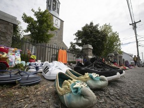Children's shoes were placed outside St-Francis Xavier Mission Catholic Church in Kahnawake following the discovery of a mass grave at the site of a former residential school in B.C.