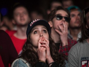 A young woman crosses her fingers as the Montreal Canadiens were losing to the Tampa Bay Lightning in game 3 of the Stanley Cup finals. Fans were watching on a big screen at the Quartier des spectacles in Montreal Friday, July 2, 202. The city of Montreal organized outdoor viewing of the game.