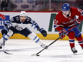 The Winnipeg Jets' Mathieu Perreault chases the Canadiens' Cole Caufield during Game 4 of second-round playoff series at the Bell Centre.