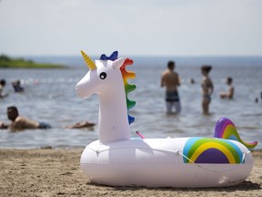 A unicorn marks a family's spot while they swim at Cap St-Jacques beach in June.  Josh Freed remembers the days when every responsible parent commanded their kids not to go swimming after eating, or “you’ll get cramps and drown.”