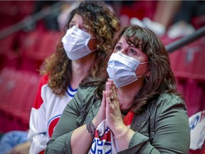 Montreal Canadiens fans watch their team lose Game 2 of the Stanley Cup finals against the Tampa Bay Lightning June 30, 2021.
