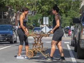 Sisters Caroline and Beatrice Gravel, right, were moving from the Plateau to Hochelaga-Maisonneuve yesterday during the annual moving day bonanza in the city.