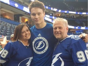 Tampa Bay Lightning defenceman Mikhail Sergachev poses with Michelle and Brian Reid, who were his billet family when he played junior hockey with the OHL's Windsor Spitfires. They taught him to speak English and adjust to life in North America after leaving Russia as a teenager.