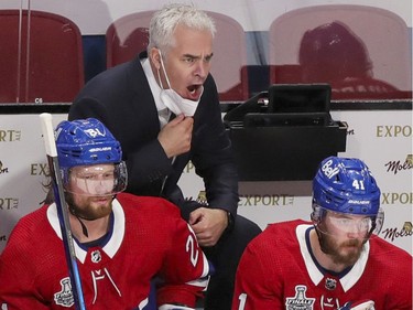 Canadiens interim head coach Dominique Ducharme yells at officials behind the bench during the first period of Game 3 of the Stanley Cup Final against the Tampa Bay Lightning in Montreal on Friday, July 2, 2021. Ducharme was back behind the bench for the first time since having COVID-19.