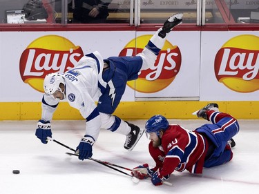 Canadiens' Joel Armia (40) takes Tampa Bay Lightning's Mathieu Joseph (7) down with him after a big hit during Game 3 of the Stanley Cup Final in Montreal on Friday, July 2, 2021.