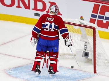 Canadiens' Carey Price fishes the puck out of the net after goal by Tampa Bay Lightning's Victor Hedman during the first period of Game 3 of the Stanley Cup Final in Montreal on Friday, July 2, 2021.