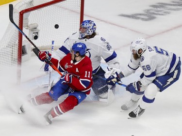 Canadiens' Brendan Gallagher crashes the net as linemate Phillip Danault's shot beats  Tampa Bay Lightning goalie Andrei Vasilevskiy and defenceman David Savard during the first period of Game 3 of the Stanley Cup Final in Montreal on Friday July 2, 2021.