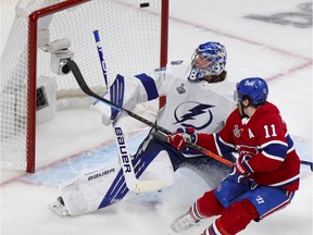 Canadiens' Brendan Gallagher crashes the net as linemate Phillip Danault's shot beats  Tampa Bay Lightning goalie Andrei Vasilevskiy during the first period of the Stanley Cup Final in Game 3 in Montreal on Friday July 2, 2021.