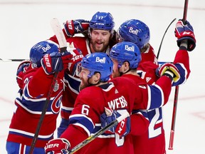 Canadiens' Josh Anderson, rear, is mobbed by teammates after scoring the winning goal in overtime during Game 4 of the Stanley Cup final Monday night at the Bell Centre.