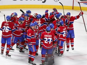 Canadiens players celebrate after Josh Anderson scored his second goal of the game in overtime for a 3-2 win over the Tampa Bay Lightning in Game 4 of Stanley Cup Final Monday night at the Bell Centre.