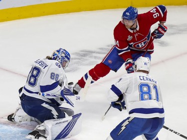 Tampa Bay Lightning goaltender Andrei Vasilevskiy (88) makes a save on a shot by Montreal Canadiens right wing Corey Perry (94) while Lightning defenceman Erik Cernak (81) watches during the first period of Game 4 of the Stanley Cup final in Montreal Monday, July 5, 2021.