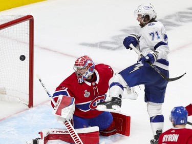 Montreal Canadiens goaltender Carey Price (31) watches a shot go wide as Tampa Bay Lightning centre Anthony Cirelli (71) provides a screen during the second period of Game 4 of the Stanley Cup final in Montreal on Monday, July 5, 2021.