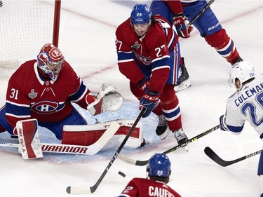 Montreal Canadiens goaltender Carey Price (31) prepares to stop Tampa Bay Lightning centre Blake Coleman (20) as Montreal Canadiens defenceman Alexander Romanov (27) attempts to tip the puck away during Game 4 of the Stanley Cup final in Montreal on Monday, July 5, 2021.
