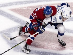 Montreal Canadiens right wing Cole Caufield (22) leans in on Tampa Bay Lightning centre Anthony Cirelli (71) during Game 4 of the Stanley Cup final in Montreal on Monday, July 5, 2021.