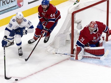 Montreal Canadiens goaltender Carey Price (31) follows the puck as defenceman Joel Edmundson (44) chases Tampa Bay Lightning left wing Ross Colton (79) during Game 4 of the Stanley Cup final on Monday, July 5, 2021.