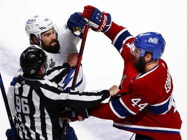 Linesman David Brisebois (96) tries to separate Tampa Bay Lightning left wing Pat Maroon (14) and Montreal Canadiens defenceman Joel Edmundson (44) during a scuffle after the first period of Game 4 of the Stanley Cup final in Montreal on Monday, July 5, 2021.