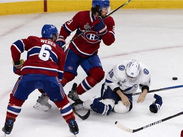 Tampa Bay Lightning left wing Ondrej Palat (18) falls to the ice after taking a hit from Montreal Canadiens defenceman Shea Weber (6) that drew a four-minute penalty during Game 4 of the Stanley Cup final in Montreal on Monday, July 5, 2021.