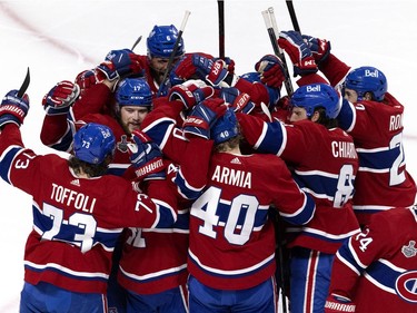 Montreal Canadiens right wing Josh Anderson (17) is swarmed by his teammates after scoring the winning goal in overtime against the Tampa Bay Lightning during Game 4 of the Stanley Cup finals in Montreal on Monday, July 5, 2021.