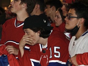 Montreal Canadiens fans react to the tying goal by the Tampa Bay Lightning in the second period of Game 4 of the Stanley Cup final outside the Bell Centre July 5, 2021.
