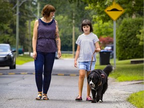 Jennifer McNamara with daughter Olivia and Olivia's support dog Momo. After a six-year wait, an educator will soon be available to help Olivia in English.