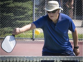 Roland Chammas returns the ball during a picketball game at the Ecclestone Park tennis courts in Kirkland on July 5.
