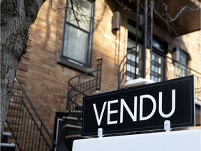 A for sale sign on a residential property in Montreal.