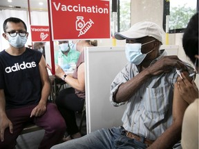 Vaccine doses are administered at a mobile clinic at a mall in Rivière-des-Prairies.
